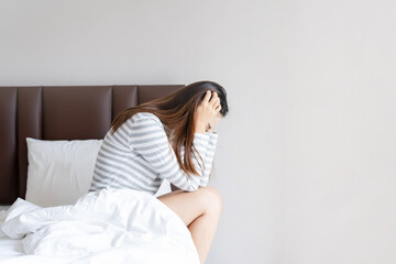 Fototapeta premium Lonely young woman depressed and stressed sitting in the bedroom, Negative emotion and mental health concept