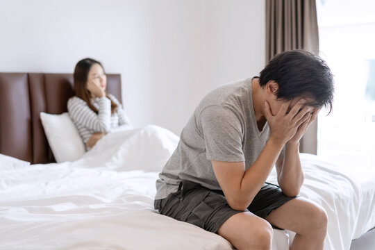 Husband feels stressed and pressured from the problem of erectile dysfunction while the disgruntled wife lay in bed after having sex