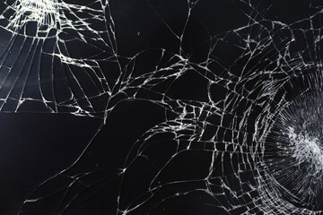 Crack on the glass. Broken screen. Broken phone. Cracked glass background. White cracks in the glass.