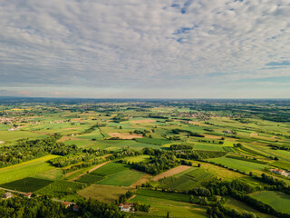 Fototapeta na wymiar Aerial view of Friuli Venezia Giulia hills and mountains in Italy, Savorgnano del Torre, Italian wine countryside, vineyards at sunset, Udine Province 