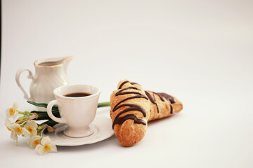 French breakfast on the table. Coffee croissant with chocolate and a decanter with cream. Fresh...