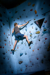 Teenage Boy Training On Climbing Wall