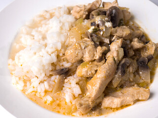 Beef stroganoff with rice on a plate. Close-up. Tasty healthy food
