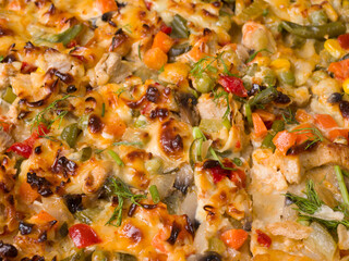 Homemade delicious pizza. Close-up. Dough, tomatoes, meat and herbs