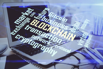 Double exposure of blockchain and crypto economy theme hologram and table with computer background. Concept of bitcoin cryptocurrency.