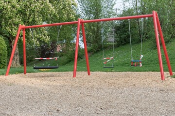 Corona virus quarantine lockdown prohibit playground swings. Closure by barrier tape. Covid-19...