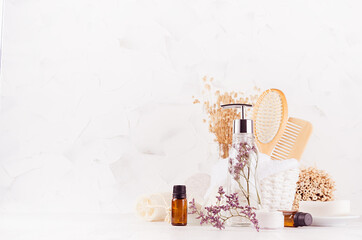 Rustic natural cosmetic products and accessories for skin and body care, aromatherapy and relaxation with lavender twig on white wood board, copy space.