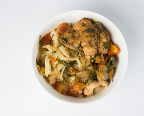 Chicken noodles in a white bowl. Home traditional cuisine