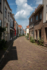 Fototapeta na wymiar Beautiful narrow streets in the center of the Hanseatic city of Zutphen with beautiful colored houses and flowers on the side of the road