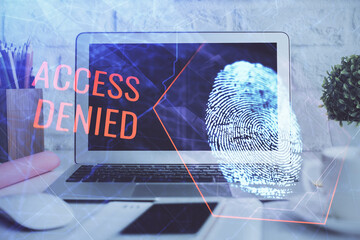 Computer on desktop in office with finger print drawing. Double exposure. Concept of business data security.