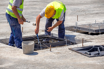 Workers installing ductile iron covers