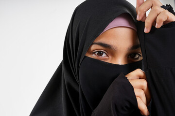 Naklejka premium Beautiful Muslim woman wearing a burka on White Background