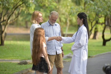 Female doctor and her elderly patient outdoor. Health and insurance concept.