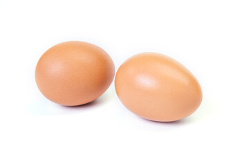 Two eggs on white background. Two brown eggs on white background.
