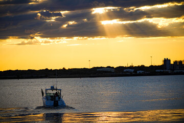 sunset over the ocean and boat