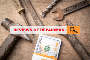 Reviews of repairman concept. Used work tools and dollar money on a wooden table. Custom work