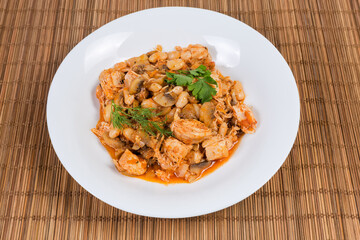Serving of stew beans with mushrooms, chicken in tomato sauce