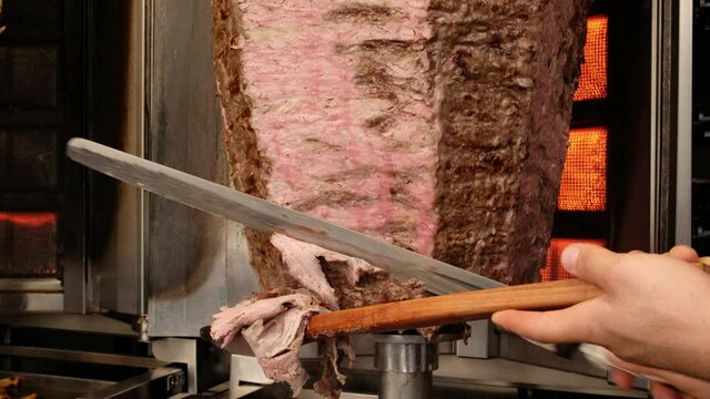 Shawarma meat being cut before making traditional Turkish Doner Kebab in Turkey