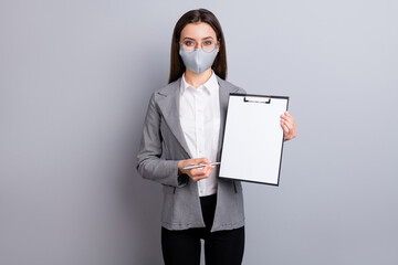 Portrait of her she attractive lady wearing safety textile mask holding in hands blank paper place...