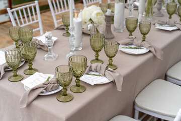 Decorated wedding table, white peonies and feathers. Chiavari chairs are at the table.