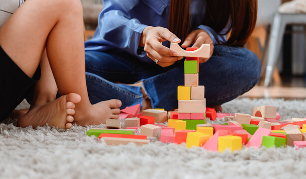 Asian Mother Work Home Together With Son. Mom And Kid Play Color Wooden Block. Child Creating Building Toy. Woman Lifestyle And Family Activity.