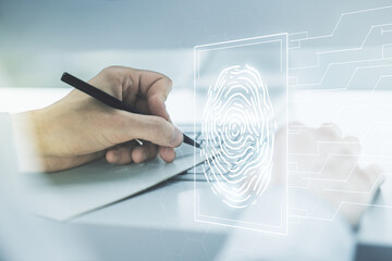 Double exposure of abstract creative fingerprint hologram with hand writing in notebook on background with laptop, research and development concept