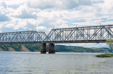 railway bridge over the river. railway crossing over the water. large iron structure on the sea