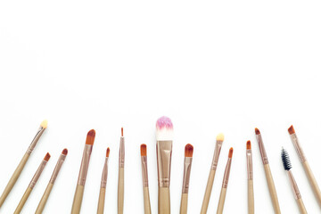 Makeup brushes on white background top view