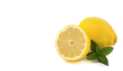 Naklejka na ściany i meble lemons whole and sliced, mint leaves, close-up on a white background, text space, horizontal view