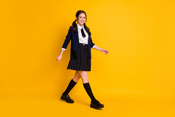 Full length body size view of her she nice attractive lovely cheerful schoolgirl going back to school autumn fall new semester season isolated on bright vivid shine vibrant yellow color background