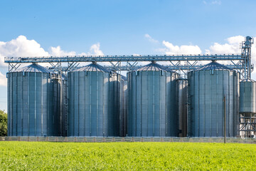 silver silos on agro-processing and manufacturing plant for processing drying cleaning and storage...