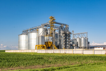 silver silos on agro-processing and manufacturing plant for processing drying cleaning and storage...
