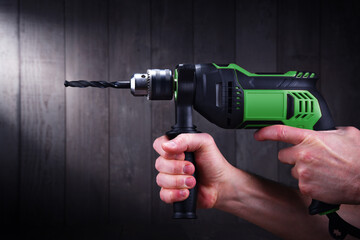 Male hands holding power drill