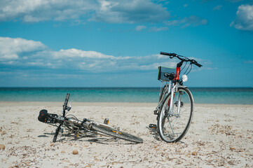 Fototapeta premium Two bicycles at the beach with blue sky