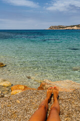 Fototapeta na wymiar Woman feet in Cala Xarraca paradise in Ibiza, Balearic Islands