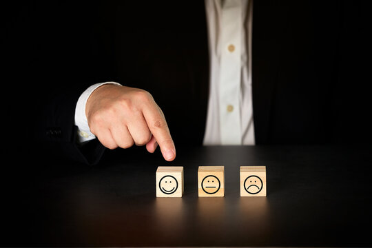 Businessman giving rating with happy icon. Satisfaction survey concept