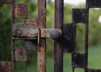 close up on the latch of an old rusty gate
