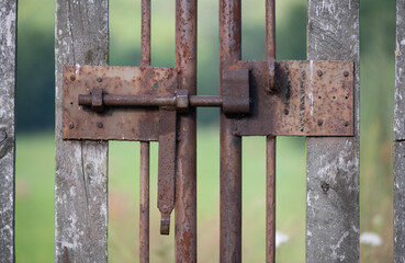 old rusty clasp on a wooden fence