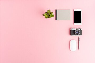 Office desktop with business accessories on pink background. Modern workspace concept. Top view