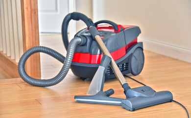 Canister vacuum cleaner for home use on the floor