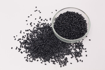 Hollow Polycarbonate Sheet Roofing Panel Colored Plastic Production. Black Color policarbonat plastic granules close up.