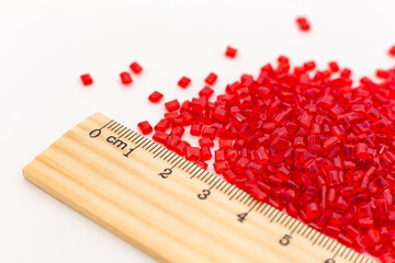 Red Color policarbonat raw materials granules close up. Hollow Sheet Panel Plastic Production