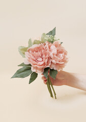 artificial flowers on beige background