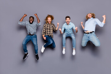 Full length photo of ecstatic guys pals hear corona virus victory news jump raise fists scream yes...