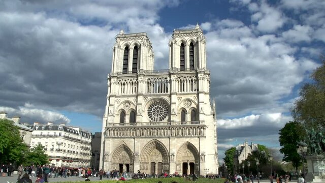 Notre Dame Cathedral in Paris, France with tourists at the front of the building. Stock Video Clip Footage