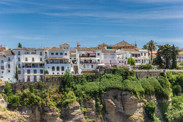 Fototapeta na wymiar White houses at the canyon in historic city Ronda, Spain