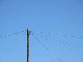 Telegraph pole with blue sky