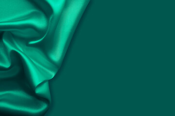 Beautiful elegant wavy emerald green satin silk luxury cloth fabric texture, abstract background...