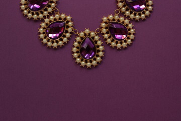 luxury purple jewelry in the Baroque style on a purple background. Vintage, retro style.
copy space
