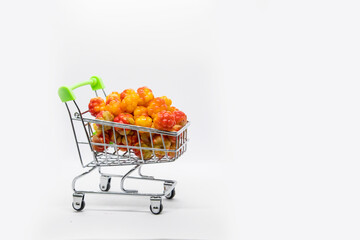 A basket full of fresh Cloudberry on a white background.